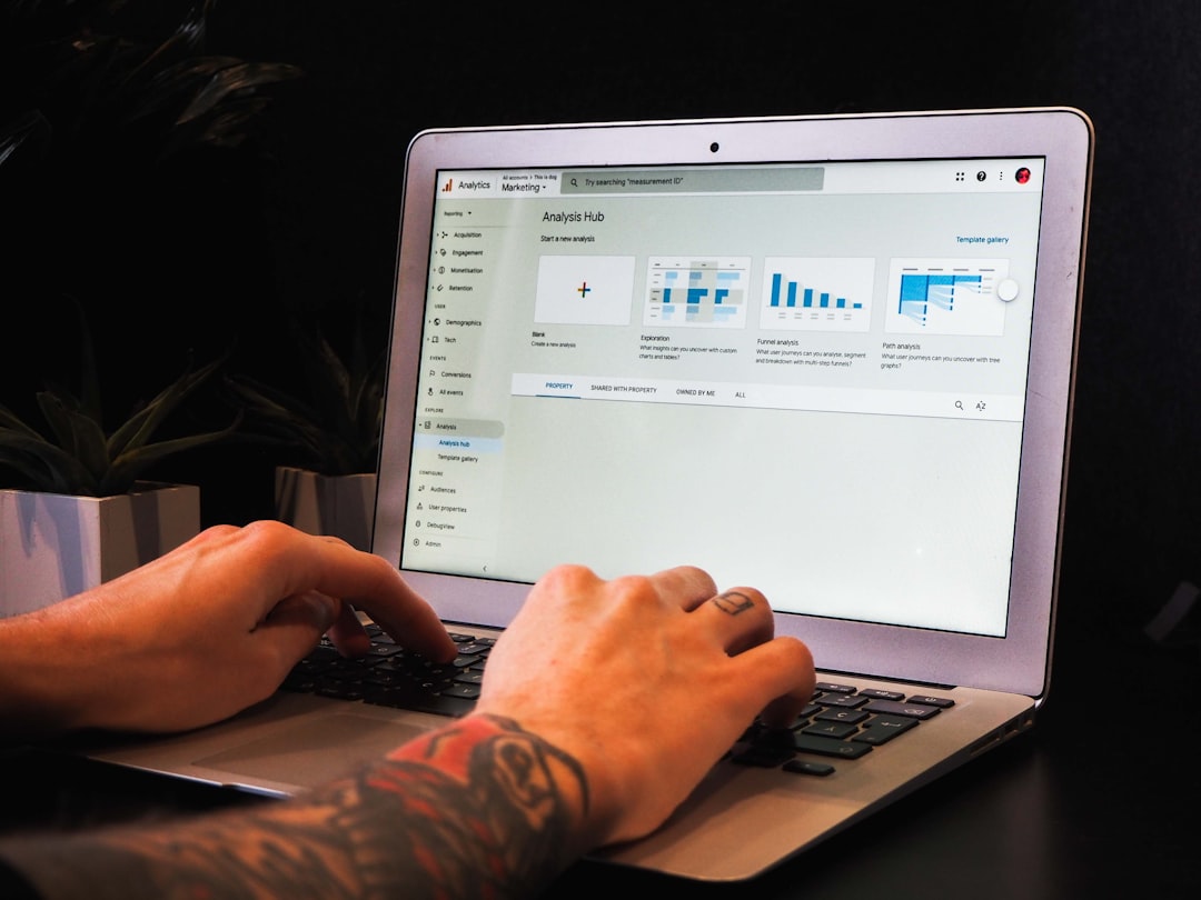 Person using macbook pro on table for How AI-Powered Chatbots Can Reduce Customer Service Costs for Small Businesses
