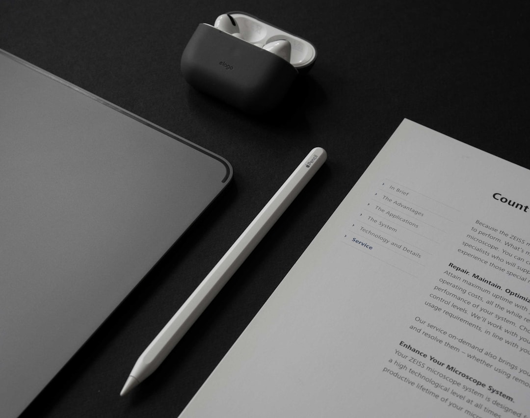 A table with a notepad, a pen, a cell phone, and a for "How Minimalist Navigation Design Improves User Experience and Conversion Rates"