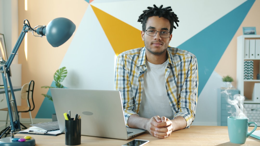 Man sitting at desk with laptop and steaming mug for "How to Find Low-Competition Keywords Your Small Business Can Actually Rank For"