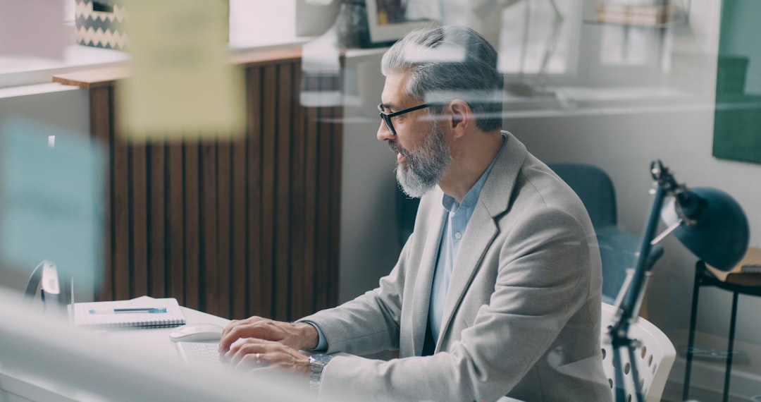 A man sitting at a desk in an office for "How to Calculate True ROI on Google Ads: A Budget Tracker Template for Small Businesses"