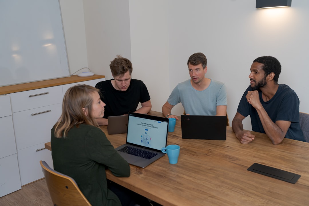 Group of people sitting on chair in front of brown wooden table for How Headless CMS Architecture Can Simplify Your Multi-Channel Content Strategy