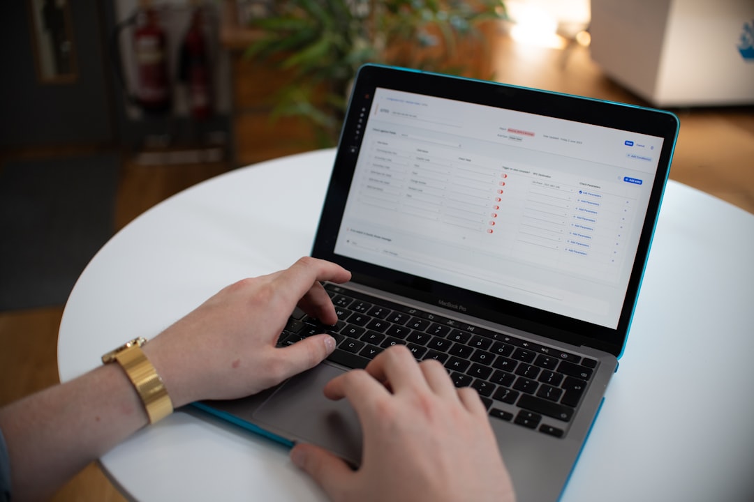 Hands typing on a laptop with a spreadsheet on screen for The Complete Guide to Finding Long-Tail Keywords Your Small Business Competitors Are Missing