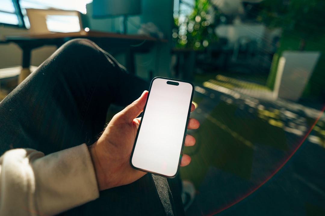 Person holding a blank screen smartphone indoors for How to Design Mobile-First Forms That Increase Conversion Rates for Small Business Websites