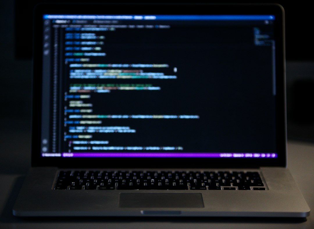 A laptop computer sitting on top of a desk for How to Choose Between Node.js and Python for Your Small Business Backend: A Practical Comparison Guide