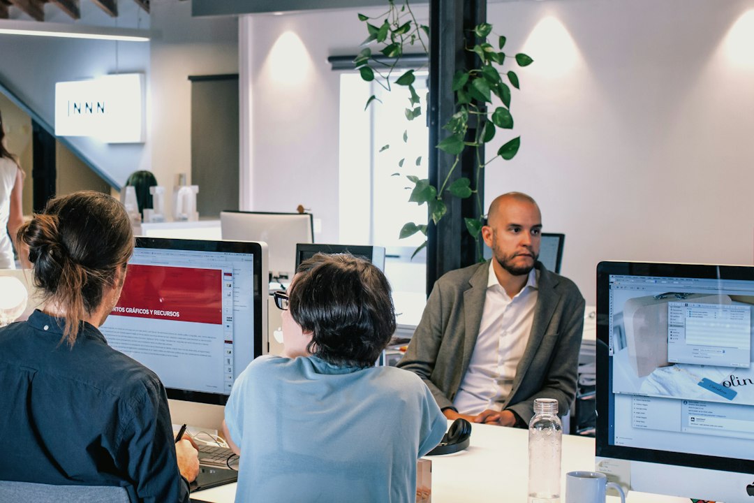 Men using computers for "How to Choose Between Figma, Adobe XD, and Sketch: A Small Business Owner's Comparison Guide"