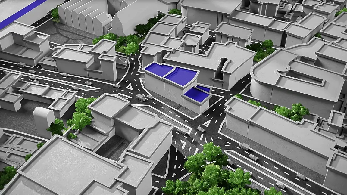 3D-Animation einer grauen Stadtmodell-Visualisierung mit Straßen, Kreuzungen und Gebäuden; einige Dachflächen leuchtend blau markiert; grüne Bäume lockern das Modell auf – digitale Stadtplanung.