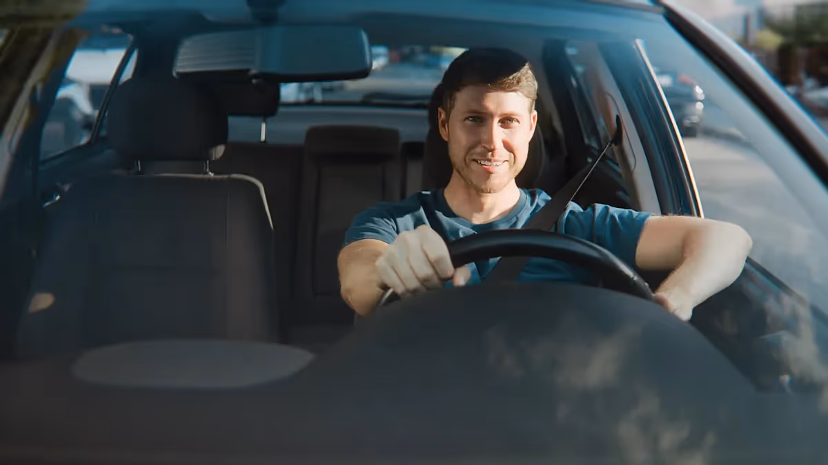 Mann fährt entspannt Auto – Szene aus einem Werbefilm einer professionellen Filmproduktion, die Alltagssituationen mit realistischer Lichtstimmung und moderner Cinematic-Ästhetik zeigt.