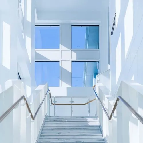 Stairs going up with windows at the end