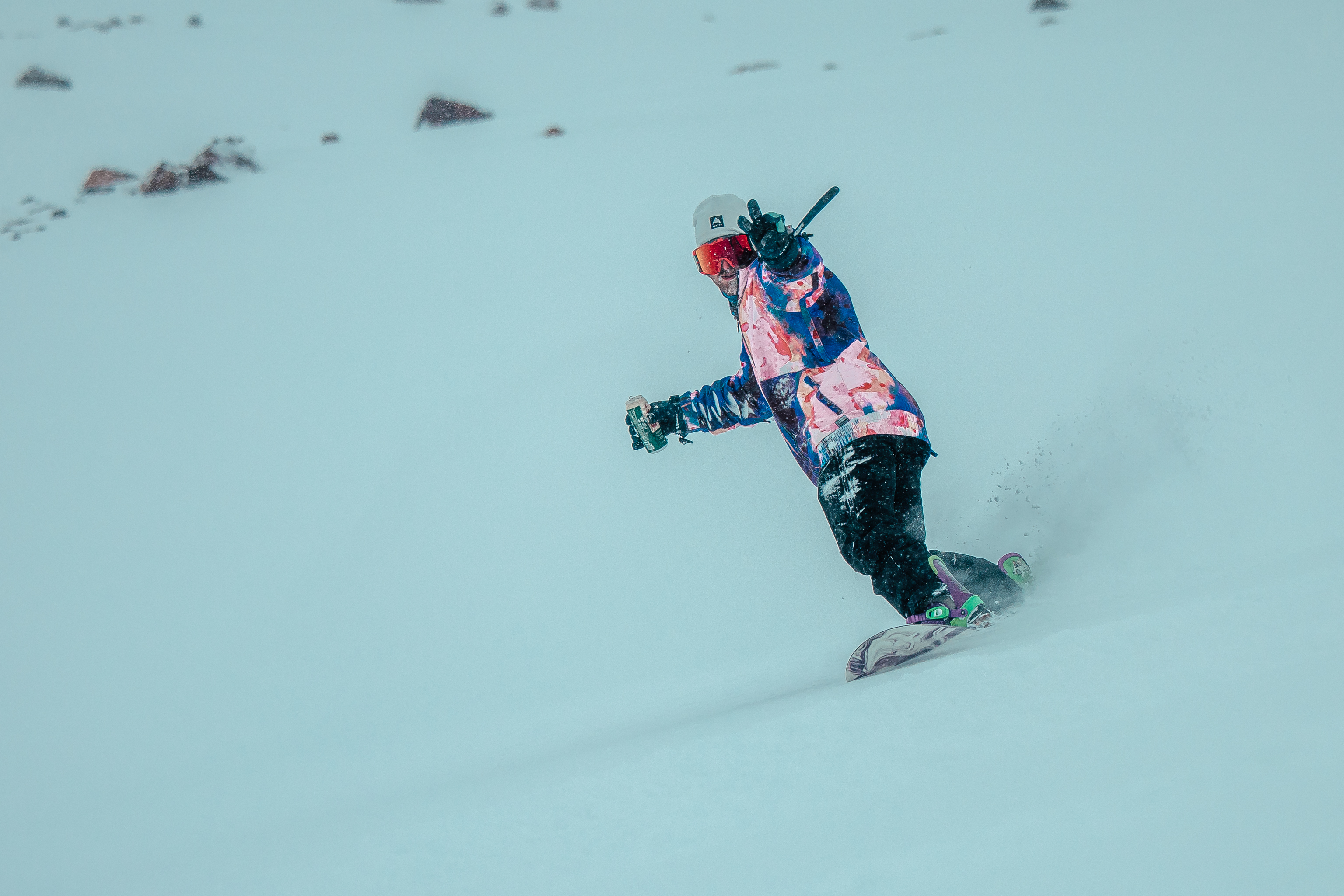 Snowboarder riding powder in Tirol
