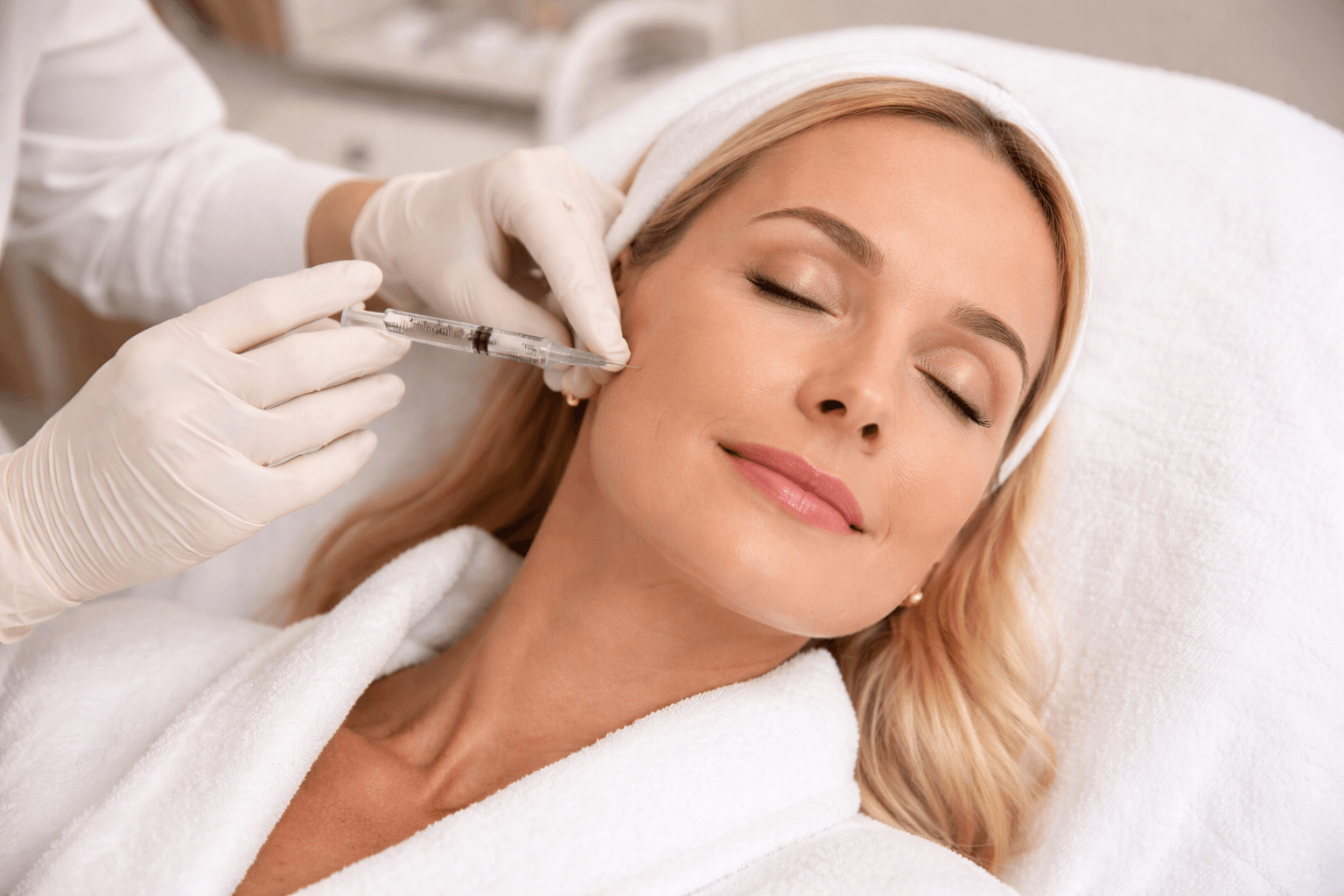 Patient receiving facial rejuvenation treatment at NAMAESTHETICS in Maitland, Florida to restore volume and improve skin texture