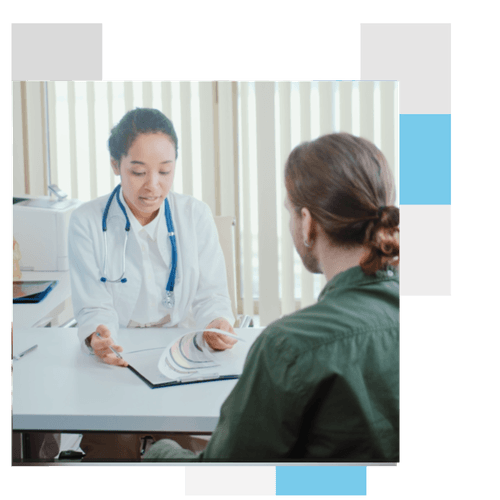 A medical professional taking to a patient holding a clipboard