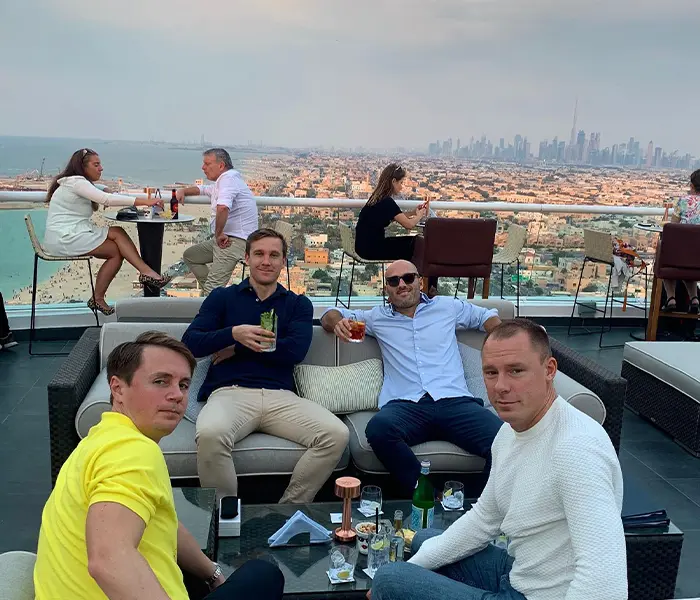 Team members enjoying rooftop drinks together at the end of a team building offsite