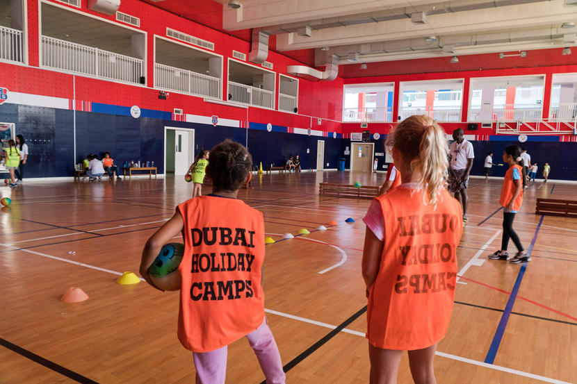 Group of kids doing ball game in gymnasium