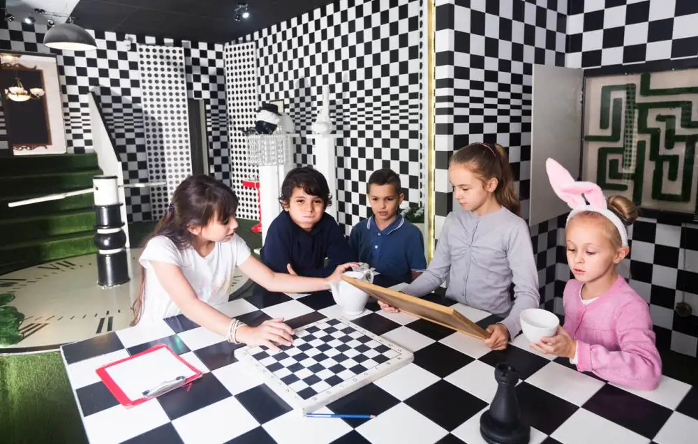 Child playing chess with friends