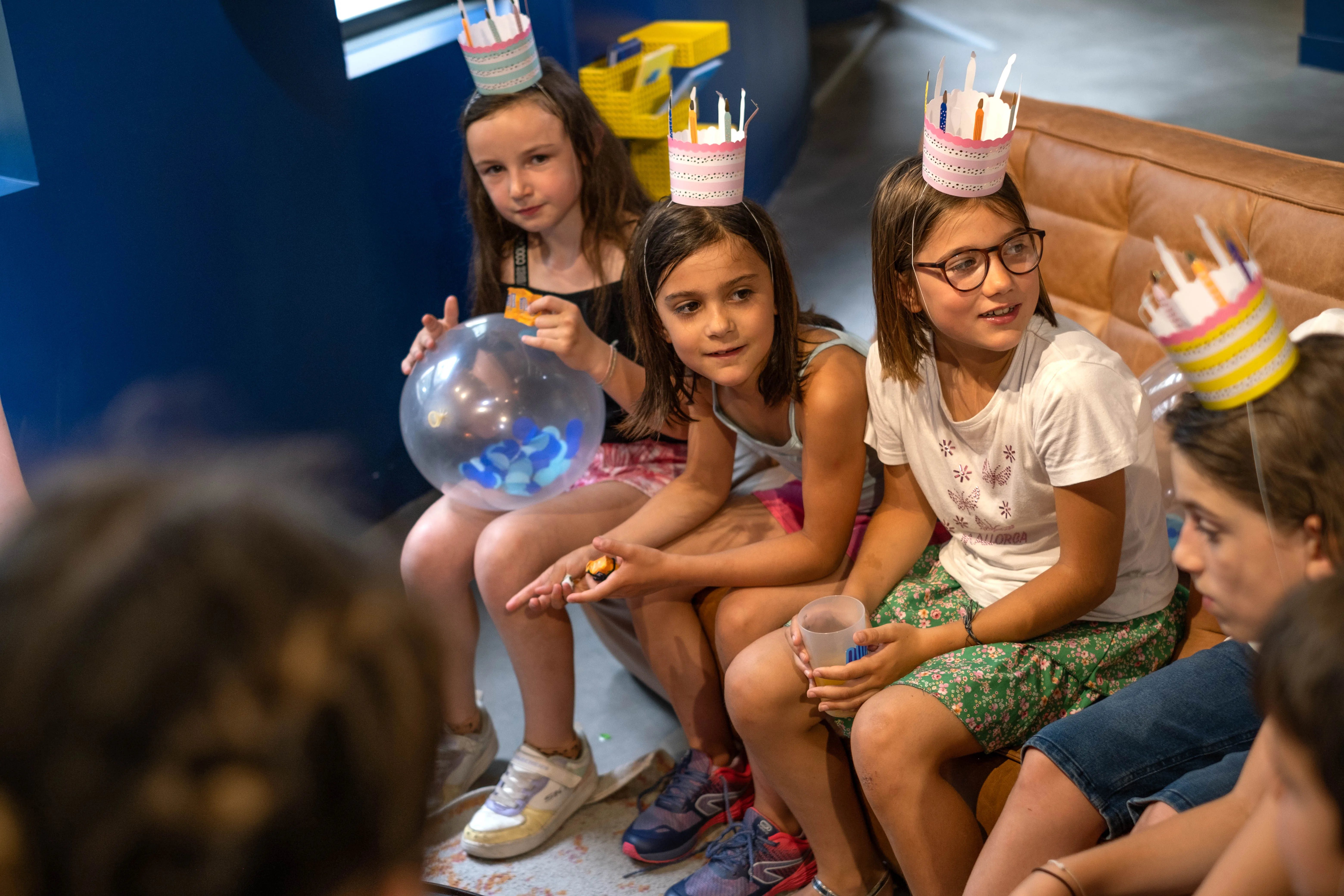 Group of happy kids celebrating together indoors