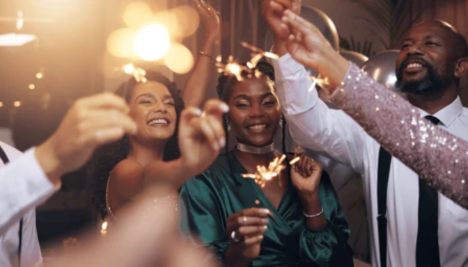 A group of adults celebrating at a party in a stylish, urban setting