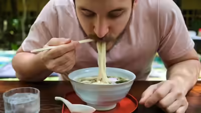 Close-up of a hot bowl of ramen with toppings in a cozy Dubai restaurant