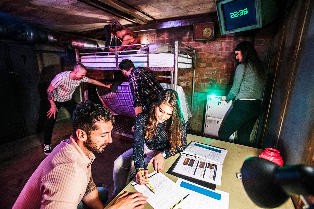 Team solving puzzles in a themed escape room setting