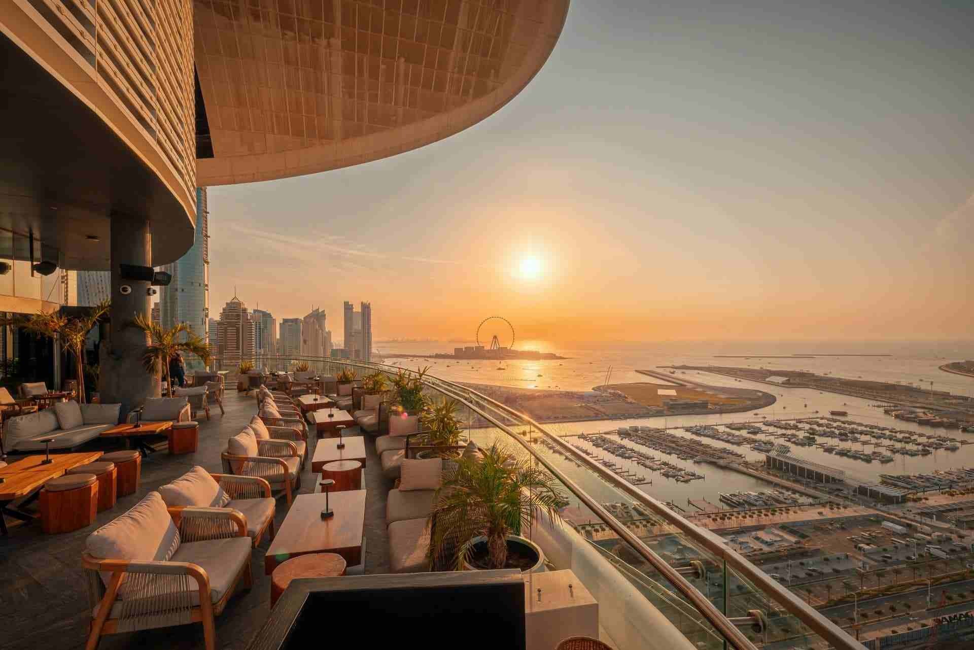 Relaxing team get-together at Dubai rooftop lounge during sunset