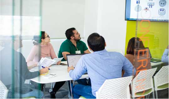  A healthcare worker wearing a face mask, protective eyewear, and a face shield, gazing out of a window.