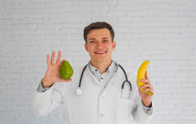 Dietician holding fruits in hands