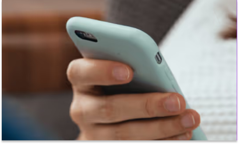 A persons hand reviewing their email from Alyta on their mobile phone.