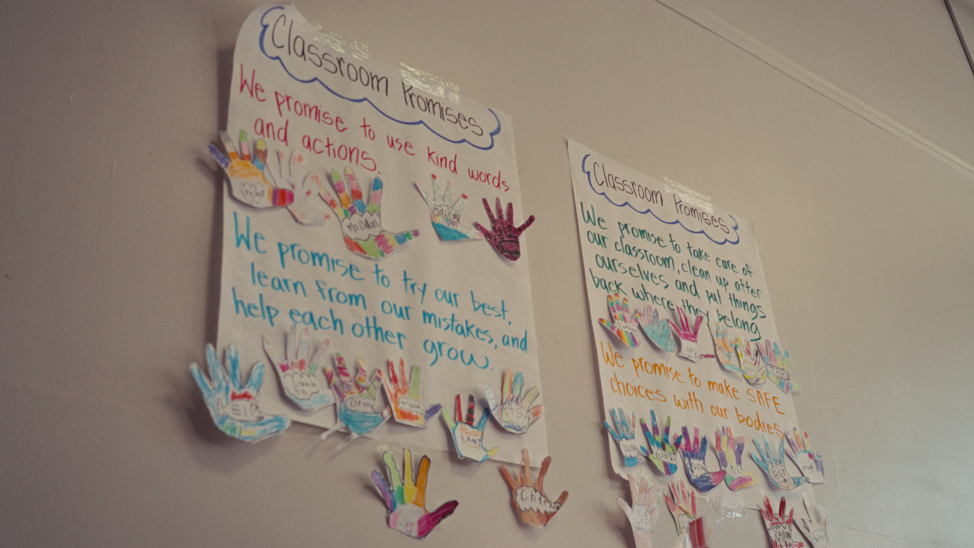 Classroom promise posters decorated with paper handprints