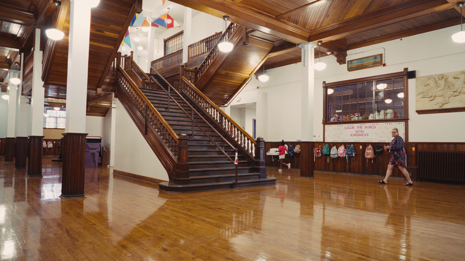 A school hallway with a wooden staircase