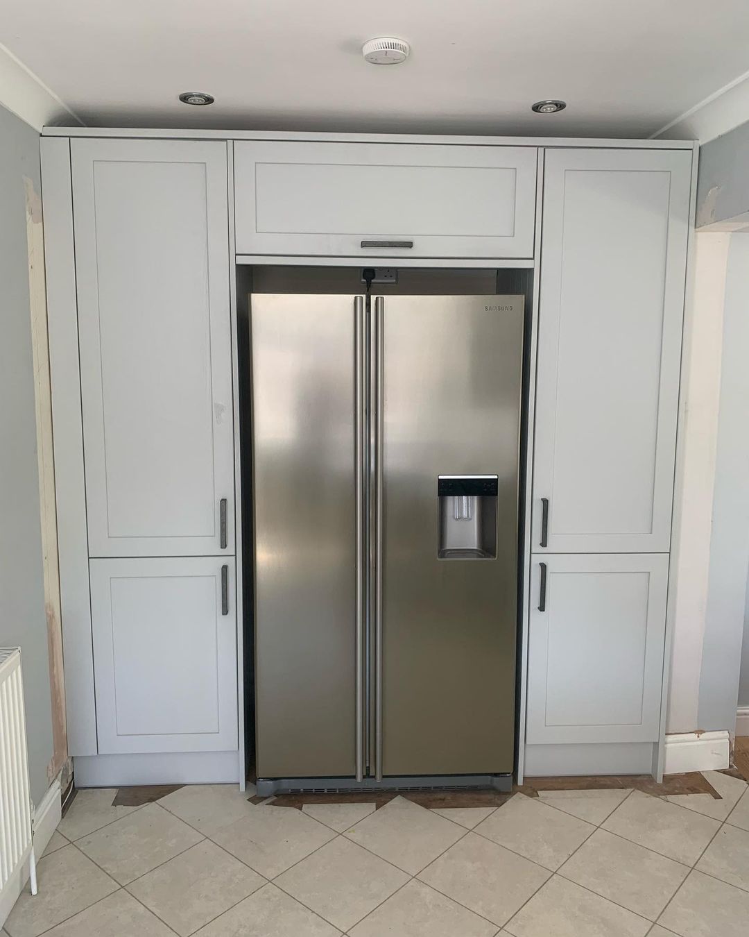 Large fridge an kitchen cabinets built by DG Home Improvements

