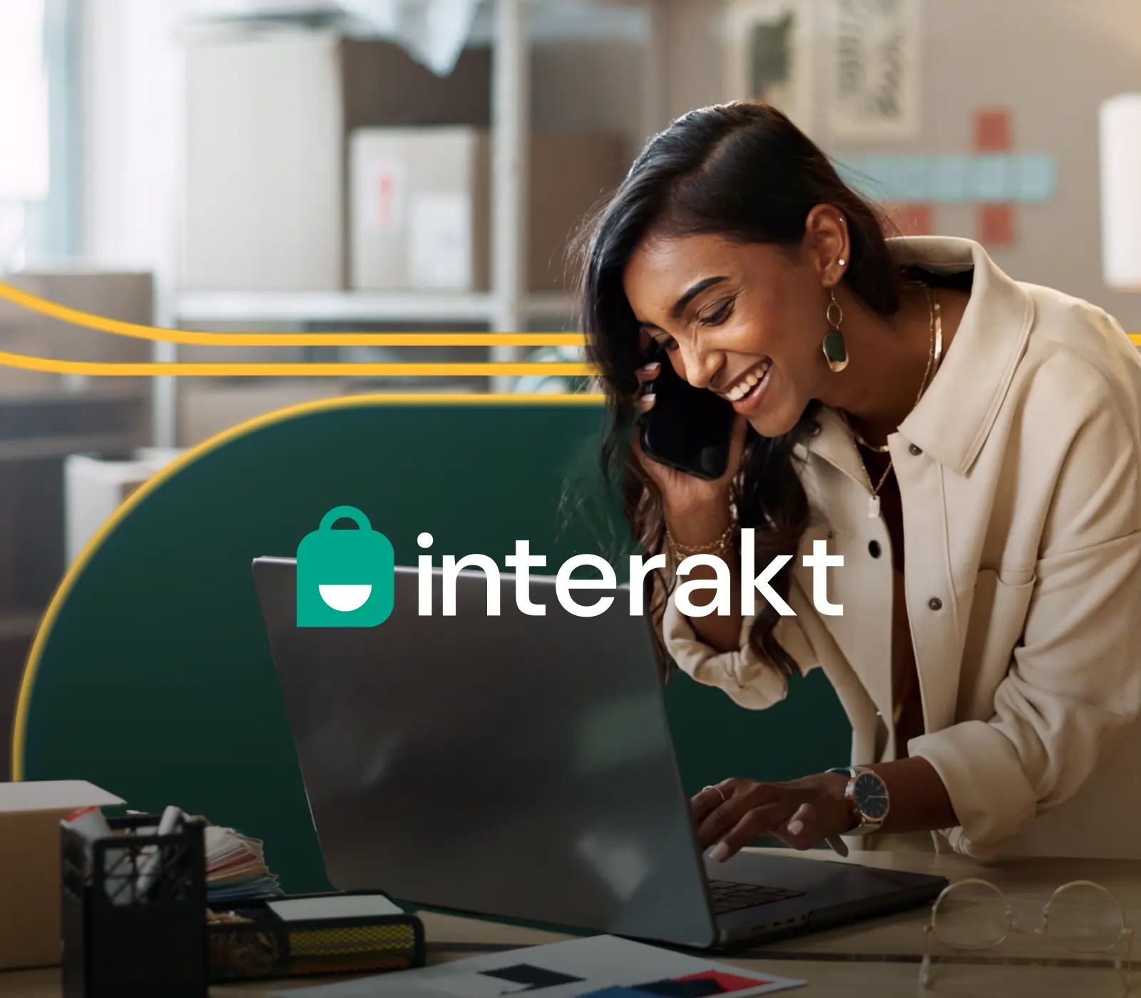Thumbnail for the case study project Interakt. It shows a woman smiling with a phone while she looks at a laptop and the Interakt logo