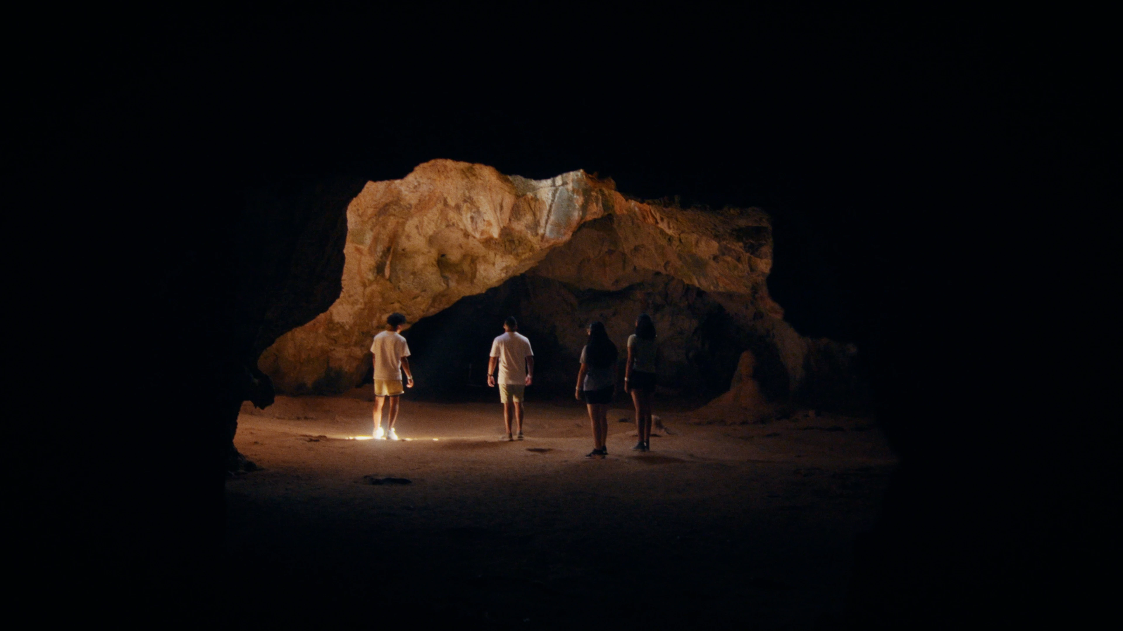 Group of people standing in an ocean side cave