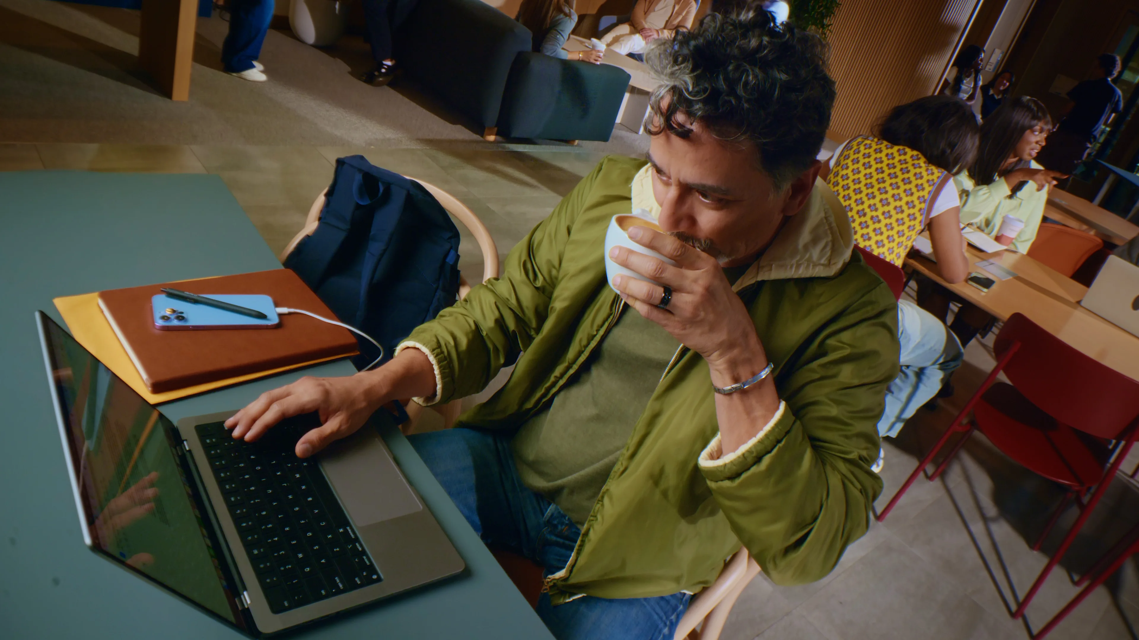 Man at computer sips latte