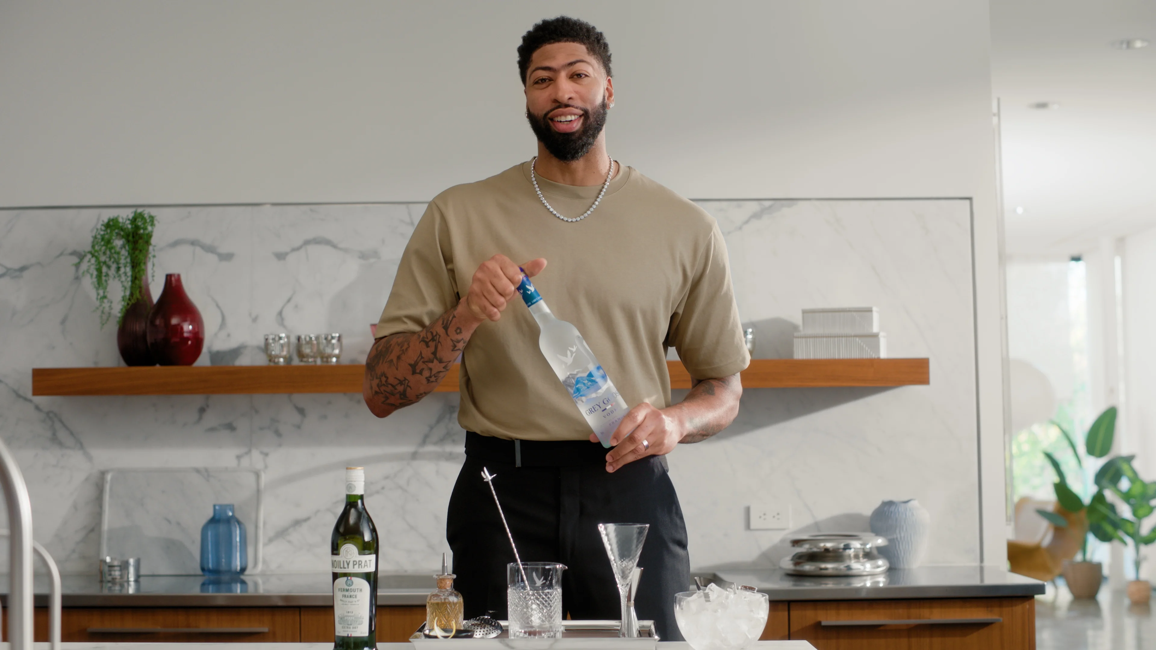 Man holding a grey goose vodka bottle