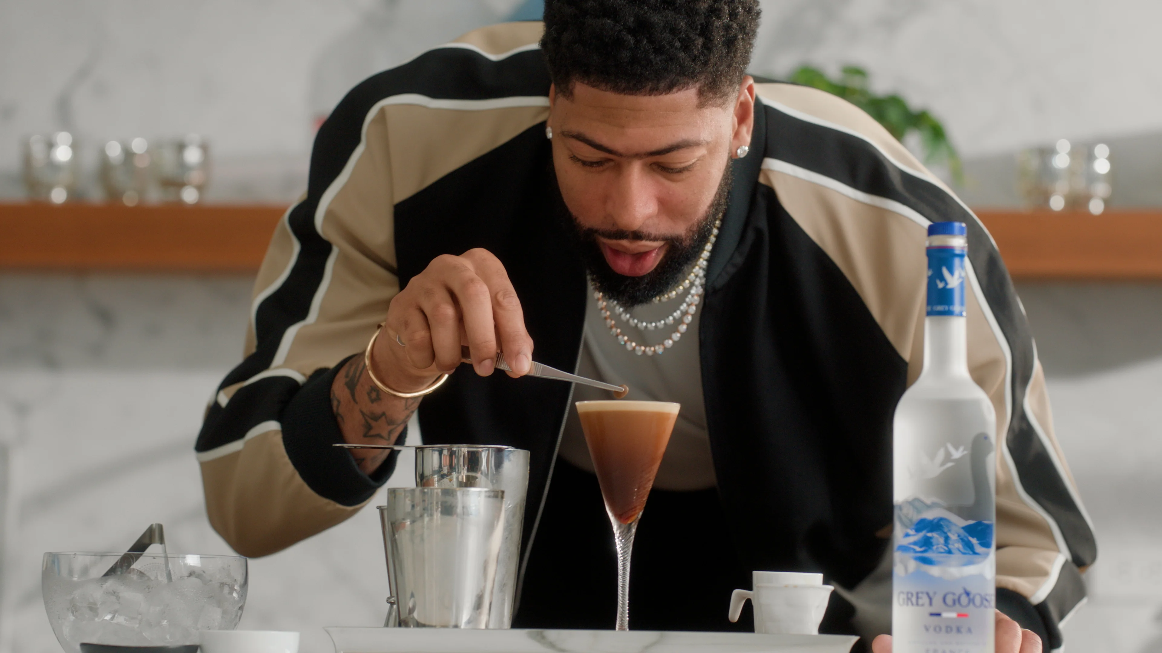Man placing a garnish on cocktail