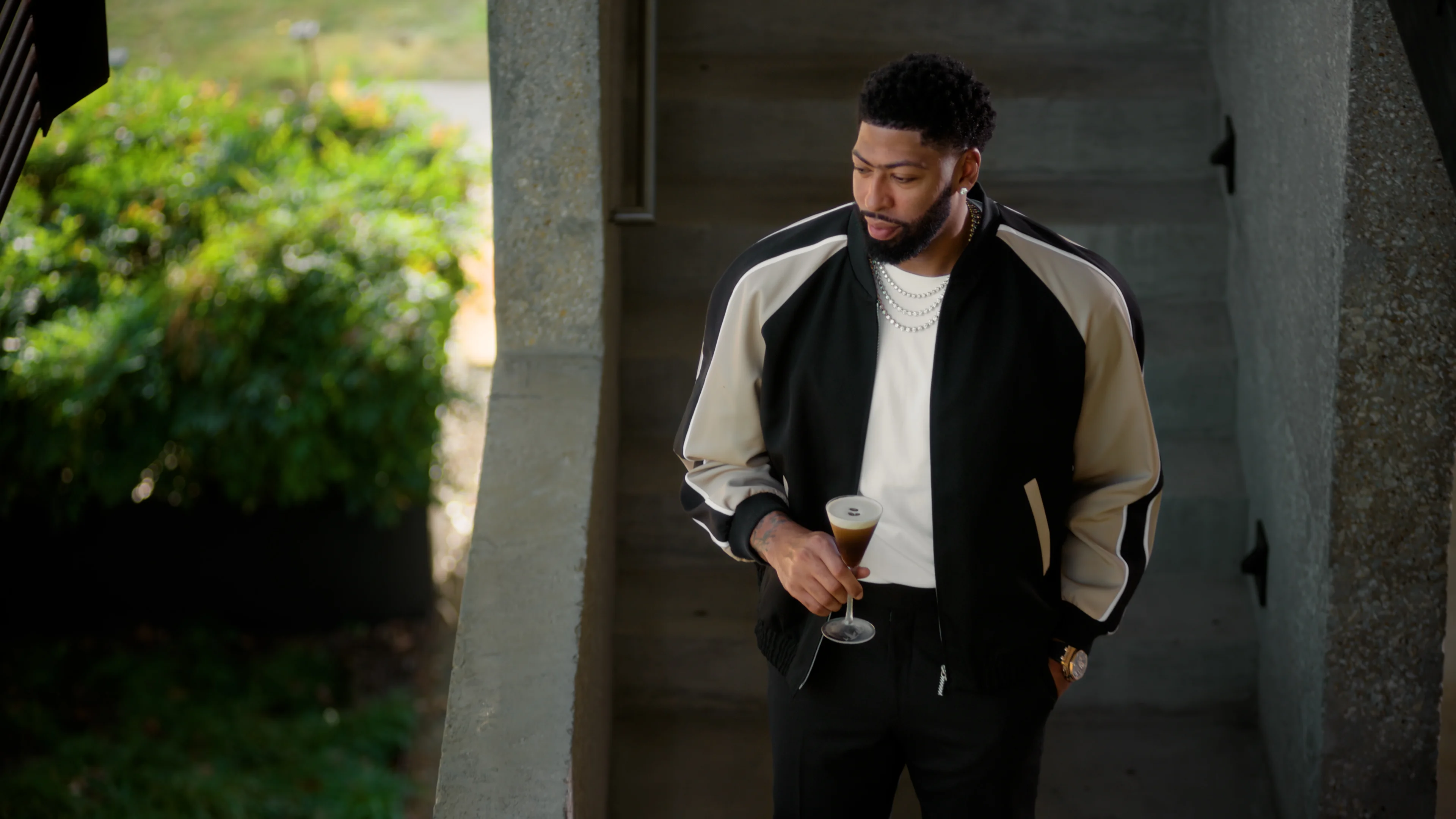 man holding a cocktail outside