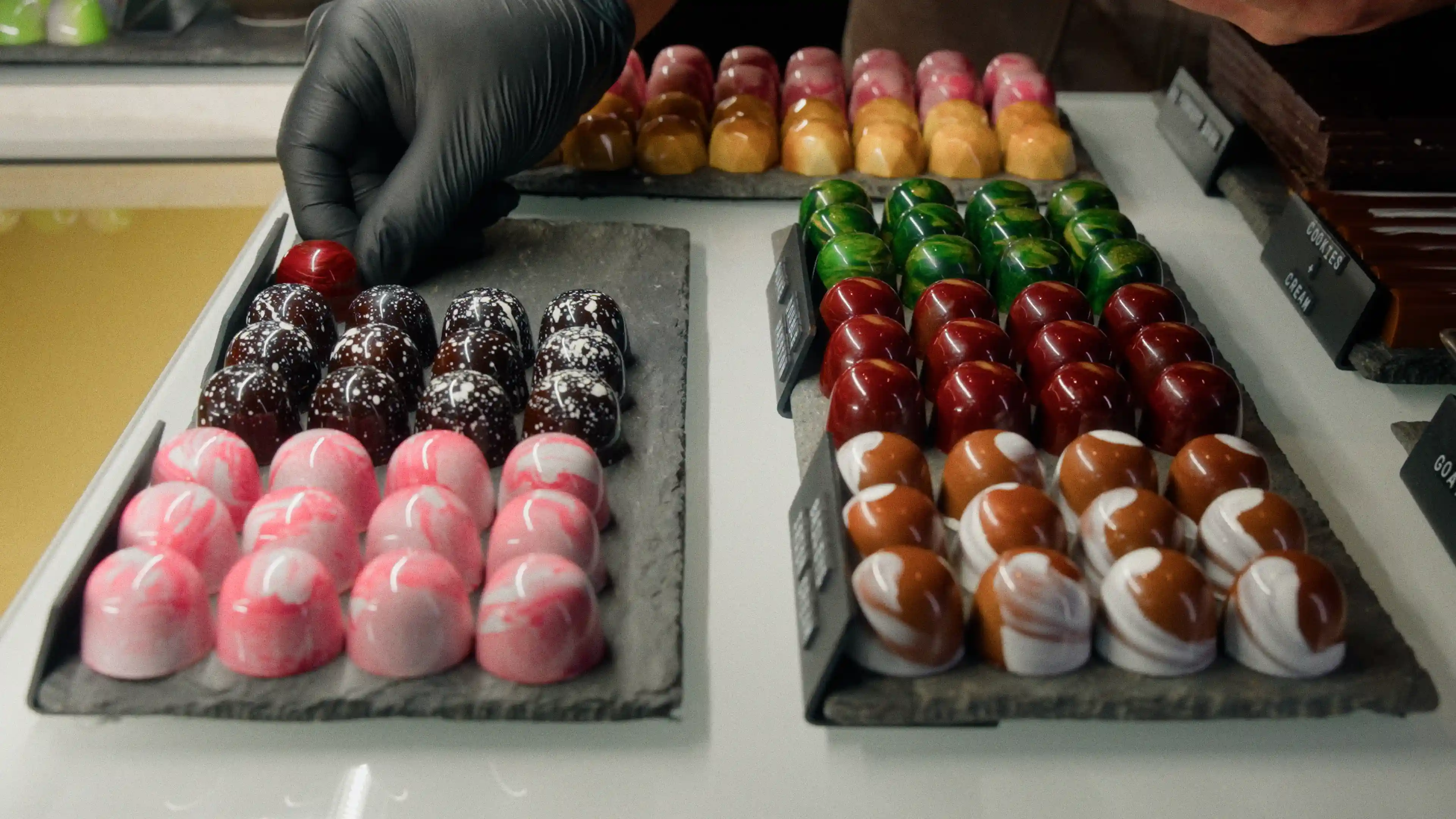 Man placing chocolate on a tray