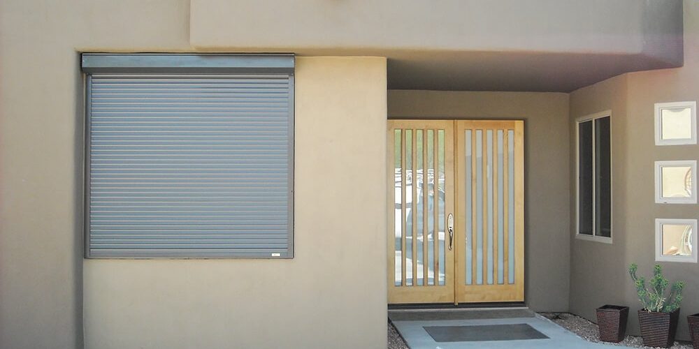 Rolling shutter next to the front door of a house.