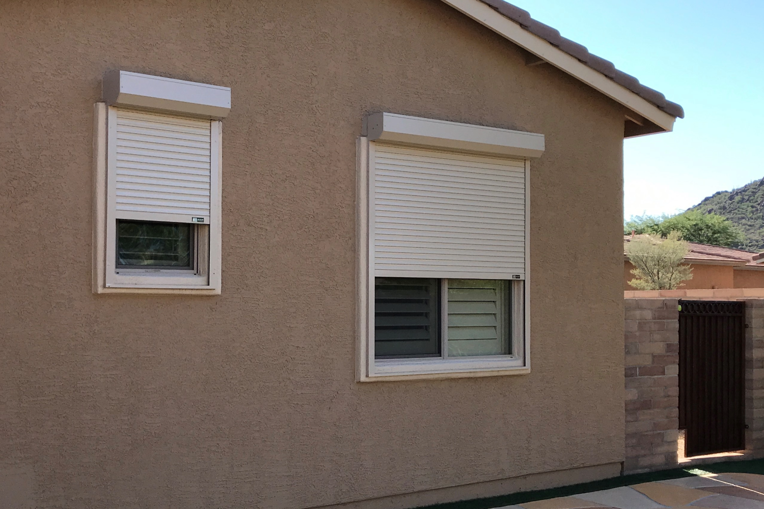 Residential home with closed rolling shutters in Phoenix.