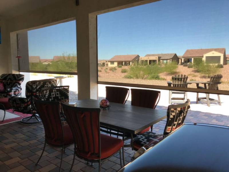 Patio with exterior screen overlooking desert.