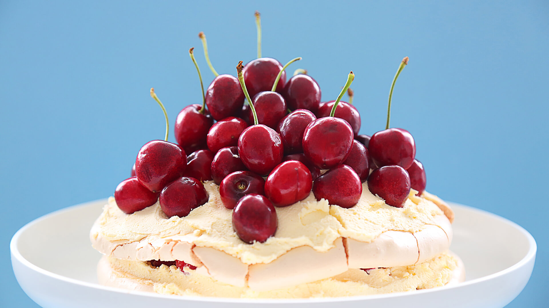 Pavlova with fresh cream and cherries