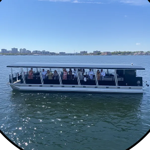 A tour boat full of people on the water.