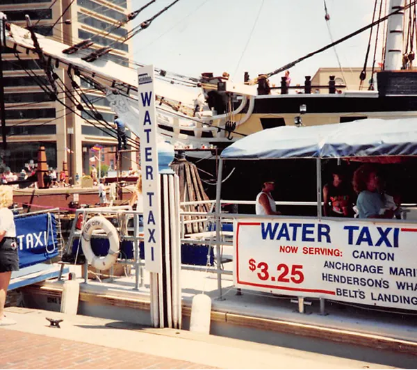 A man and a woman are standing on a boat.