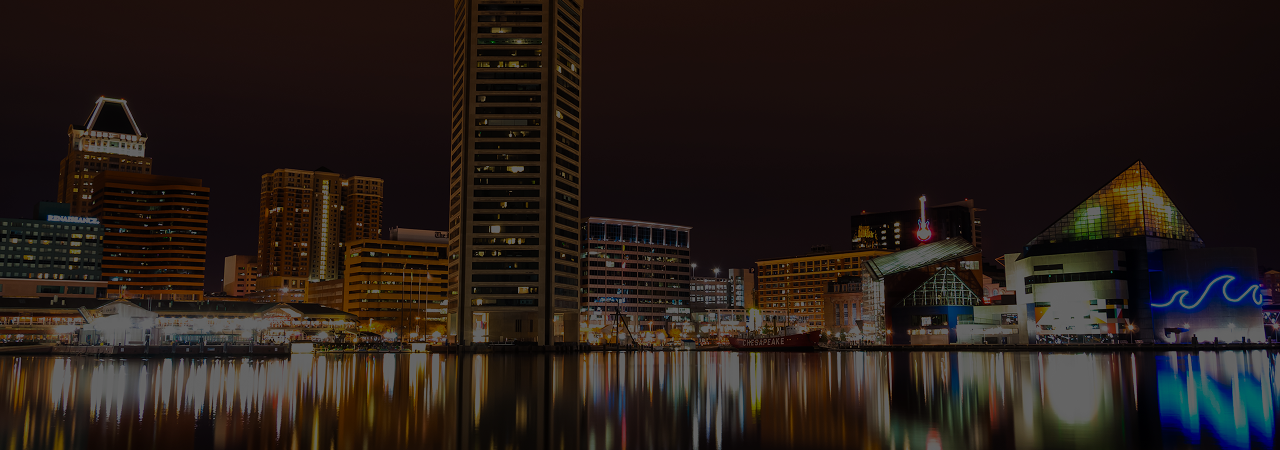 A city at night with lights reflecting in the water.