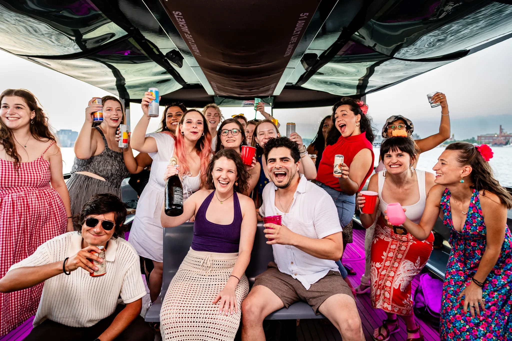 A group of people on a boat posing for a picture.