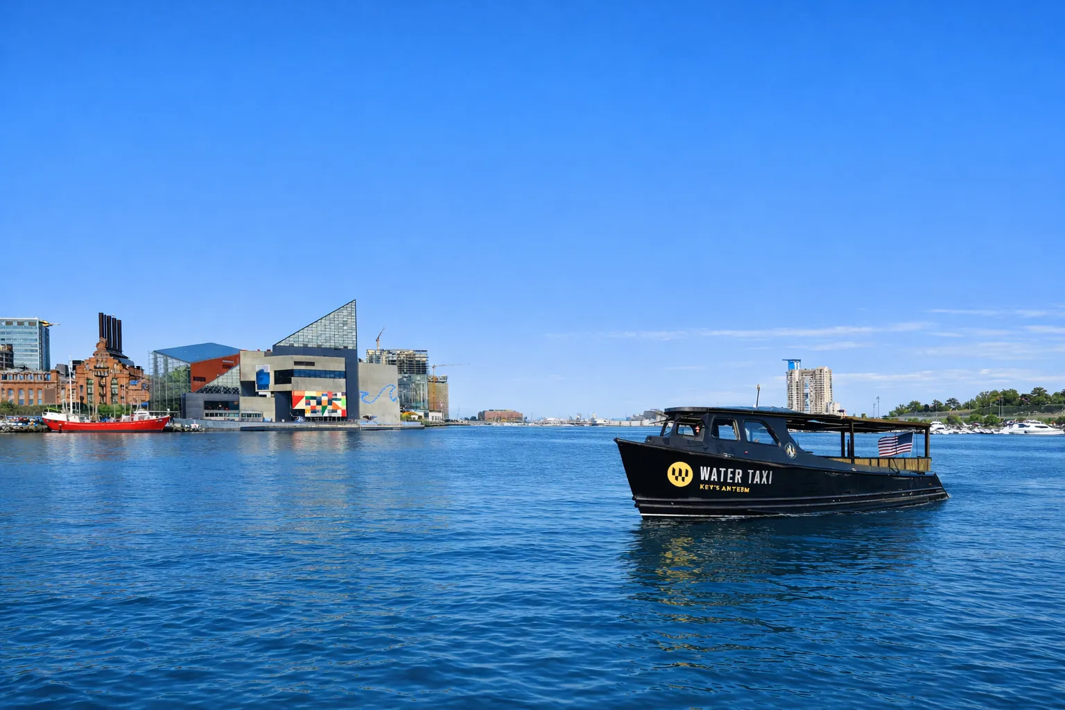 A black boat floating on top of a body of water.
