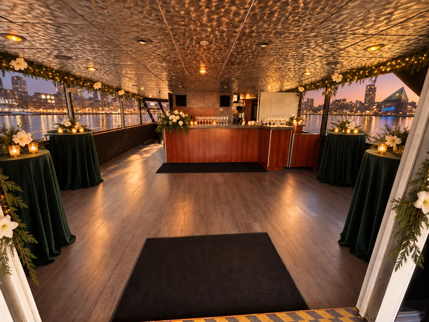 The upper salon entry and bar aboard Lady Thames set with cocktail tables and champagne