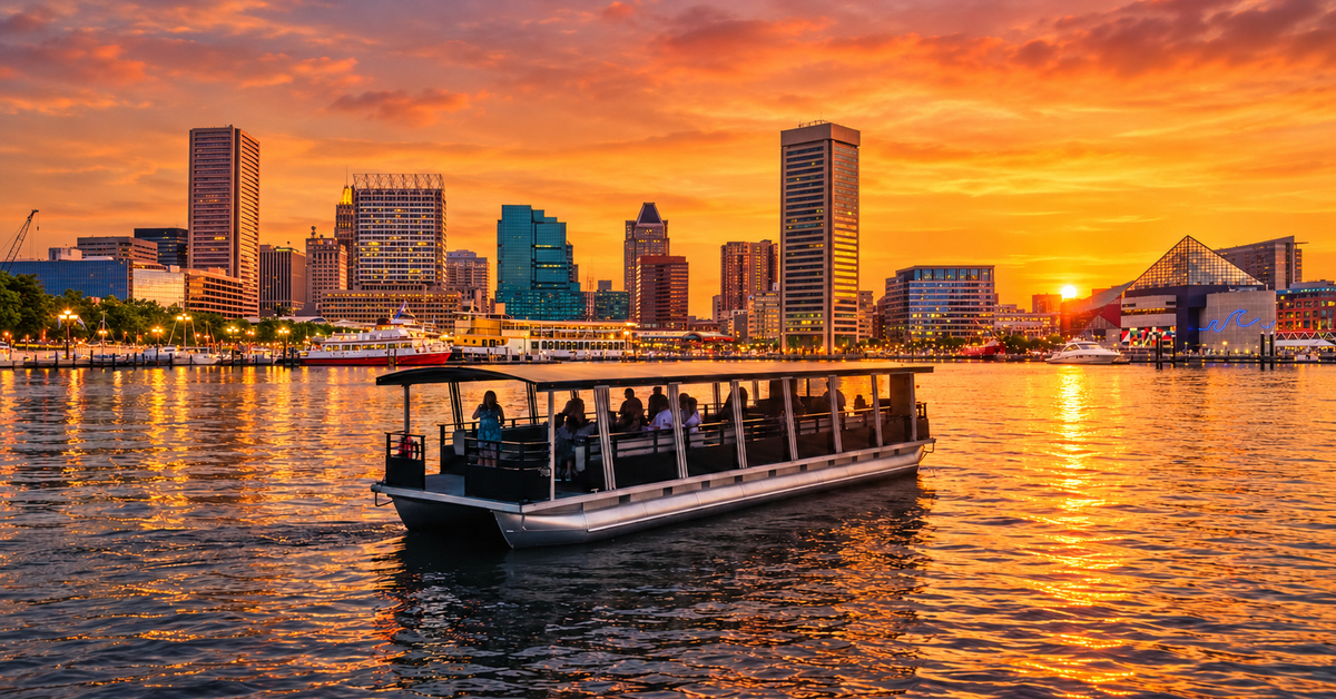 A Partytoon with guests on board at sunset in the Inner Harbor