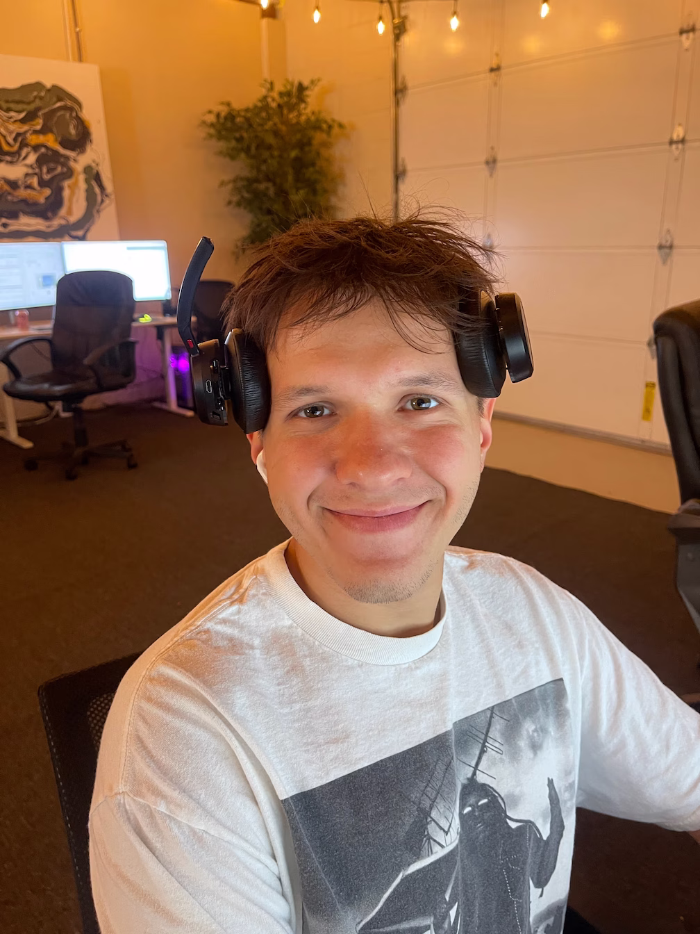 Smiling team member wearing a headset in the office, representing a happy and friendly worker at All Seasons Cleaning Services.