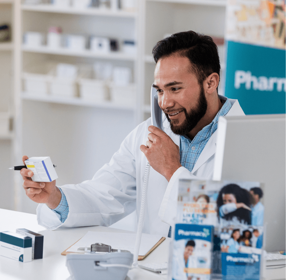 Illustration of a healthcare professional and a pharmacist discussing data on a large digital display, symbolizing collaboration in pharmacy and healthcare settings