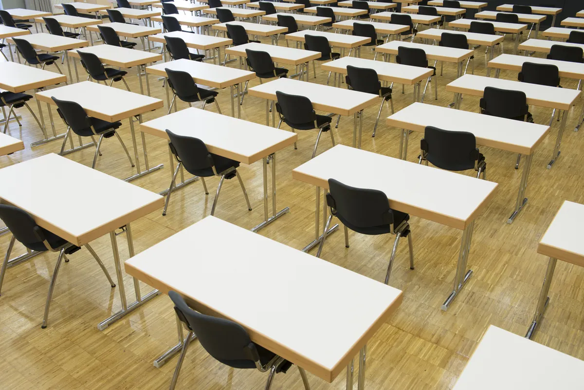 Single desks spaced to invigilation standards in a London exam venue